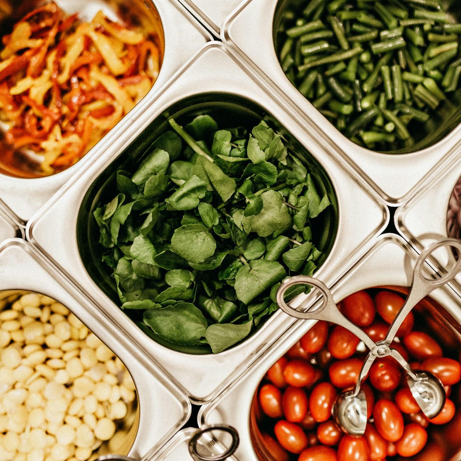 Diverse group of community members sharing a meal together, showcasing the social bonds formed through collaborative cooking